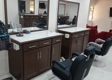 Chic interior at Mesha’s Hair Studio💗 in San Fernando, TT featuring modern styling chairs and mirrors.