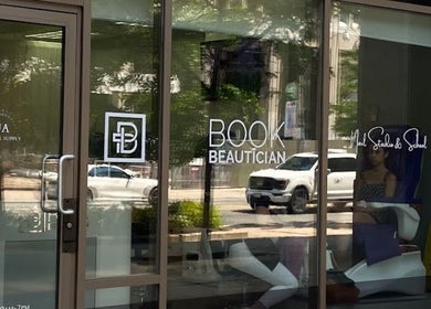 Entrance of a beauty venue with glass doors in Toronto, Ontario, CA, showcasing NYRELLI Skin + Laser.