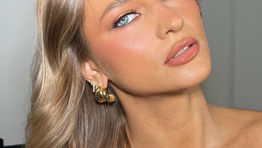 Close-up of elegant makeup at Makeup with Pim, Cheltenham, Victoria, AU, highlighting flawless skin and gold earrings.
