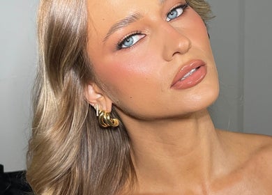 Close-up of elegant makeup at Makeup with Pim, Cheltenham, Victoria, AU, highlighting flawless skin and gold earrings.