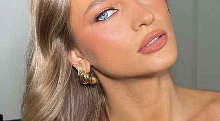 Close-up of elegant makeup at Makeup with Pim, Cheltenham, Victoria, AU, highlighting flawless skin and gold earrings.