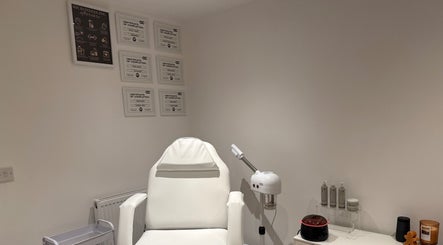 Treatment room at Melted Perfections, Billericay, England, GB, featuring a white chair and beauty equipment.