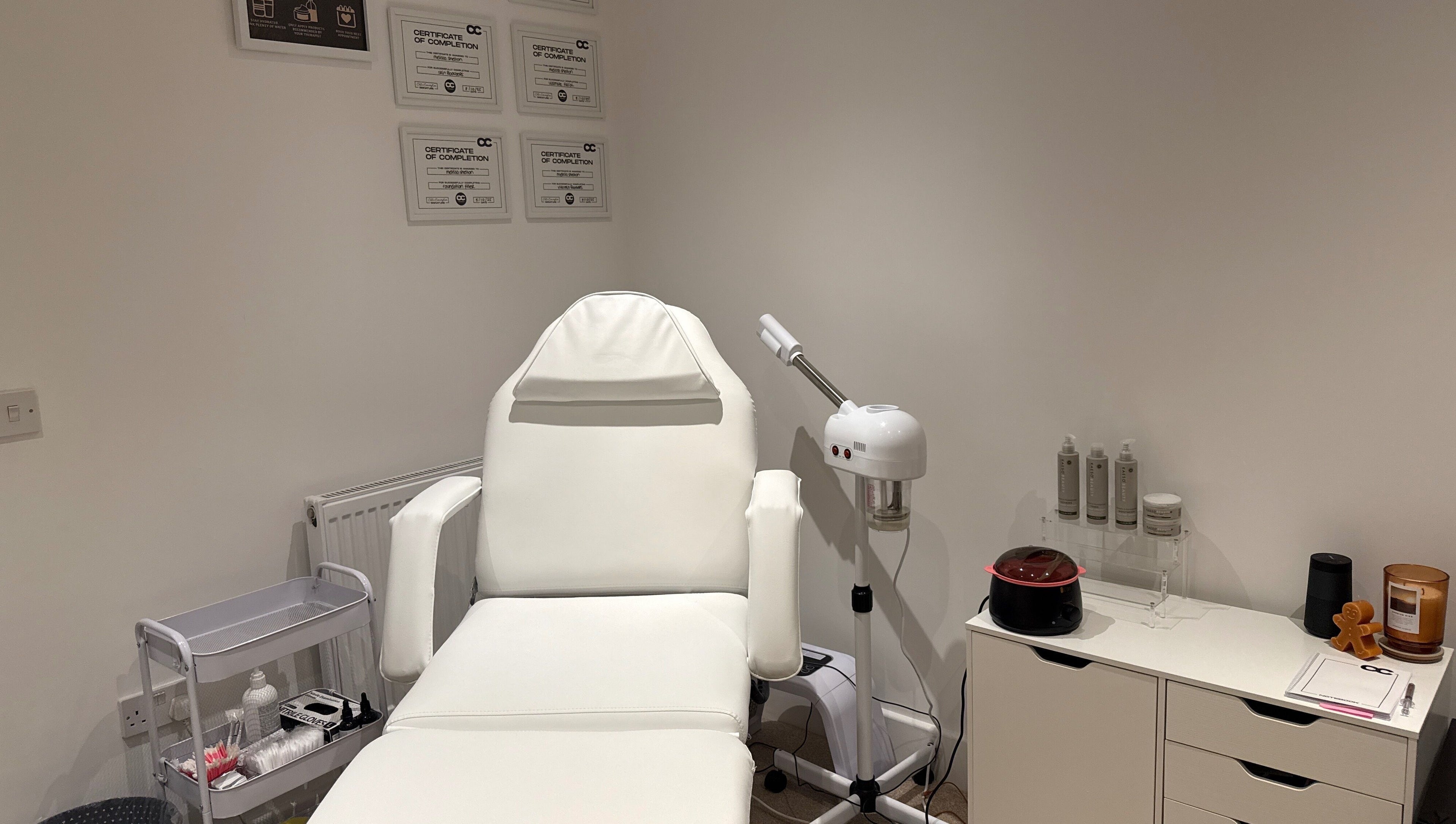 Melted Perfections spa room in Billericay, England, showcasing a treatment chair and equipment.