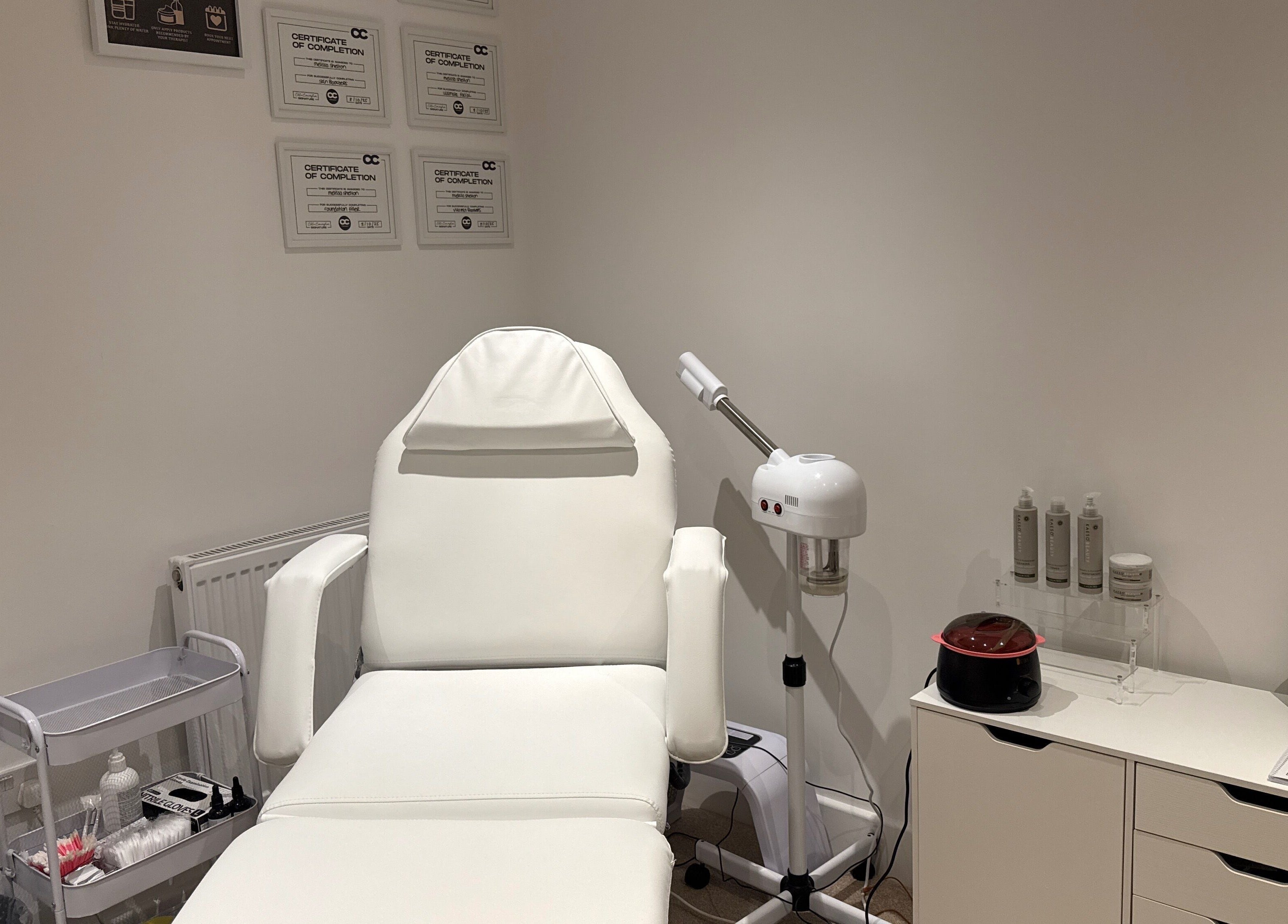 Melted Perfections spa room in Billericay, England, showcasing a treatment chair and equipment.