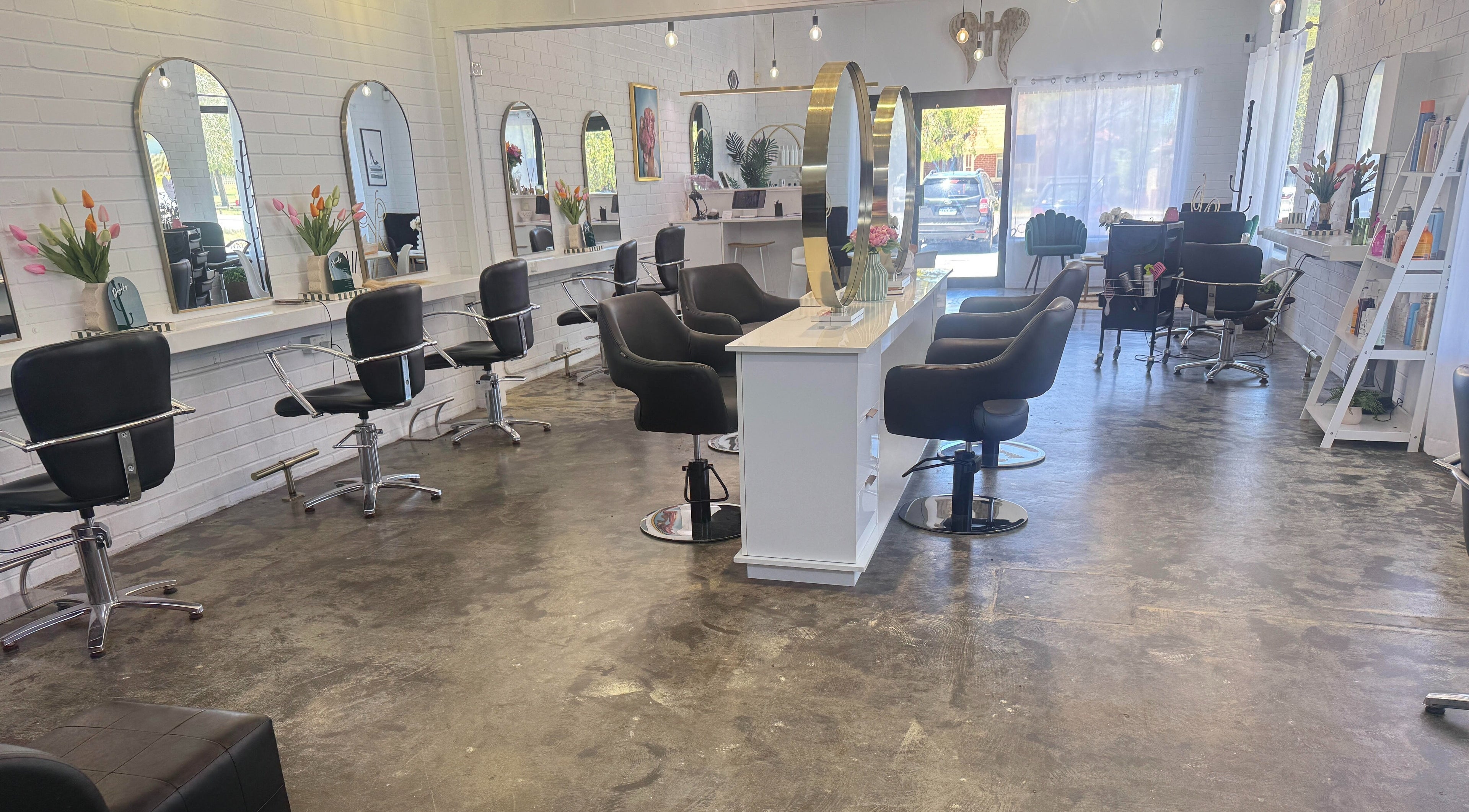 Bright, modern salon interior at NKD Hair Studio, Dianella, Western Australia, AU with stylish chairs and mirrors.