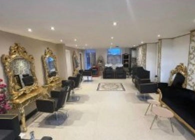 Luxurious salon interior at The Hairdeck in Pudsey, England, GB with ornate mirrors and plush seating.