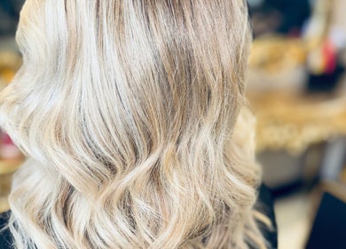 Elegant blonde waves styled at The Hairdeck, Pudsey, England, GB, showcasing modern salon expertise.