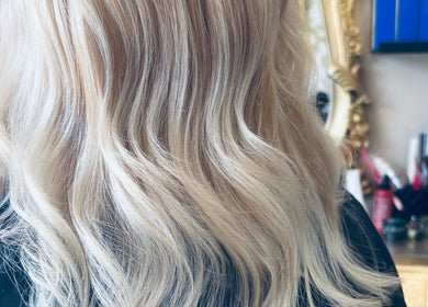 Stylish blonde hair at The Hairdeck in Pudsey, England, GB, featuring wavy highlights.
