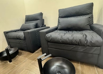 Comfortable black chairs in SGC Barbershop, Dubai, Dubai, AE, offering elegant and plush seating for relaxation.