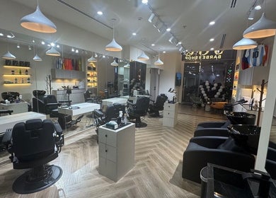 Modern interior of Sgc Barbershop in Dubai, AE featuring sleek chairs and stylish lighting.