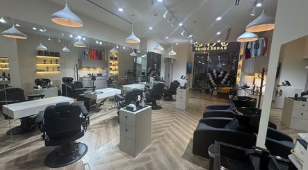 Modern interior of Sgc Barbershop in Dubai, AE featuring sleek chairs and stylish lighting.