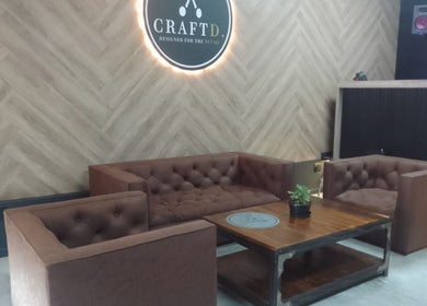 Elegant seating area at CraftD Studios in Randburg, Gauteng, ZA with plush couches and wooden decor.