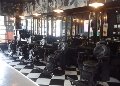 Elegant salon interior at CraftD Studios in Randburg, Gauteng, ZA, showcasing vintage barber chairs and sleek decor.