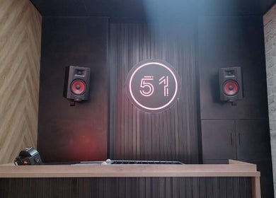 Modern sound system at CraftD Studios, Randburg, Gauteng, ZA, featuring vibrant speakers and neon sign.