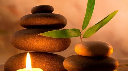Calming zen stones with a candle at Massage to You Newbury (mobile service), Newbury, England, GB.