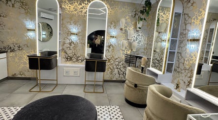 Sophisticated salon at THE BEAUTY BAR GROUP, Durban, Kwazulu-natal, ZA, featuring modern gold accents and elegant mirrors.