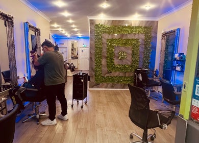 Beautiful salon interior at Vani Beauty, London, England, GB with modern decor and hairstylist working.
