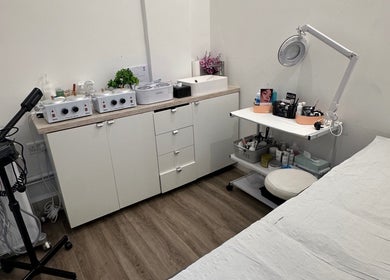 Cozy treatment room at Vani Beauty, London, England, GB, featuring massage table and professional equipment.