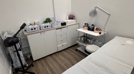 Cozy treatment room at Vani Beauty, London, England, GB, featuring massage table and professional equipment.