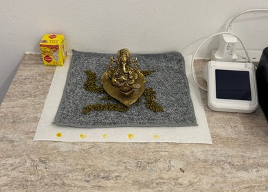 Elegant Ganesh statue on a textured mat at Vani Beauty, London, England, GB. A serene space accentuating calmness.