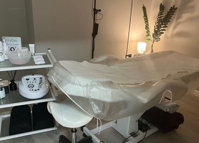 Relaxing treatment room at My Skin Sanctuary, Eastbourne, England, GB, featuring a massage table and skincare products.