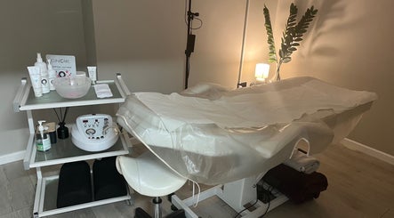 Relaxing treatment room at My Skin Sanctuary, Eastbourne, England, GB, featuring a massage table and skincare products.