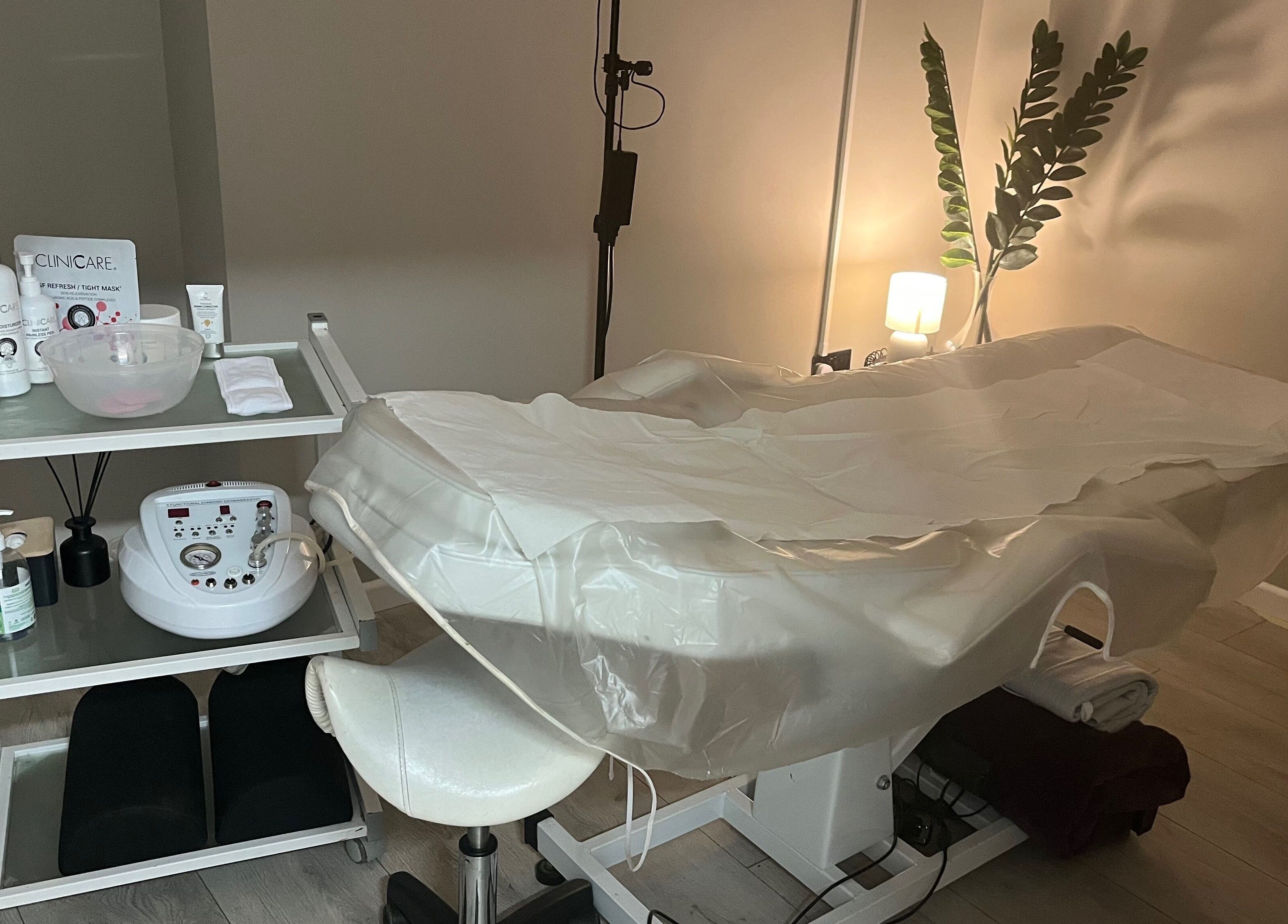 Spa treatment room at My Skin Sanctuary, Eastbourne, England, GB, featuring a serene bed and beauty products.