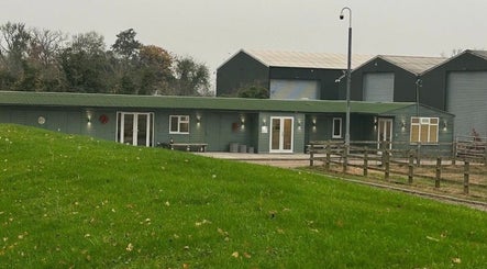 Exterior of The Aesthetics Retreat Academy, nestled in lush greenery in Warburton, England, GB.