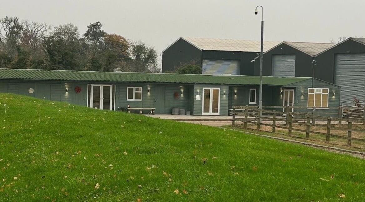 Exterior of The Aesthetics Retreat Academy, nestled in lush greenery in Warburton, England, GB.