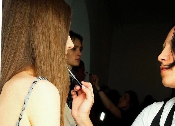 Makeup artist at Maria Ovejero Beauty in Kortrijk, Vlaanderen, BE applying makeup with precision.