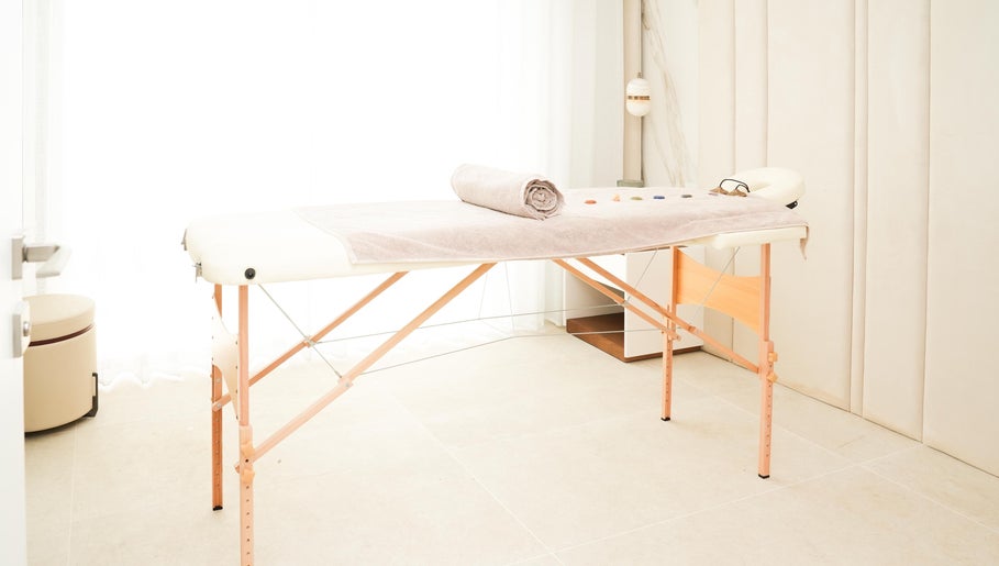 Therapy room at Energy Flow Therapy, Hale, England, GB with massage table and calming decor.