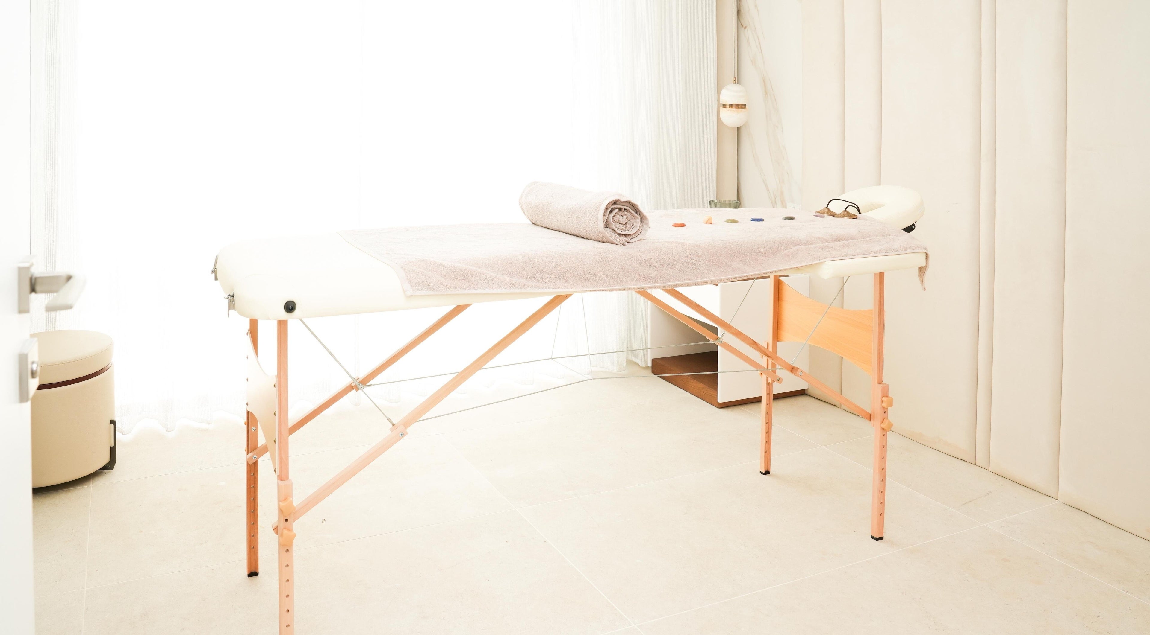 Therapy room at Energy Flow Therapy, Hale, England, GB with massage table and calming decor.