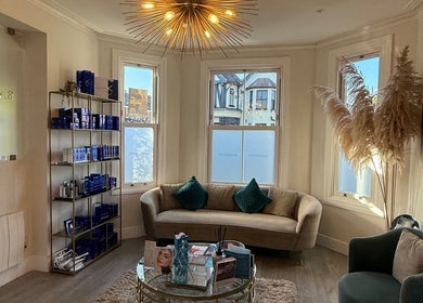 Inviting lounge at Energy Flow Therapy, Hale, England, with elegant decor and a cozy atmosphere.