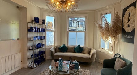 Inviting lounge at Energy Flow Therapy, Hale, England, with elegant decor and a cozy atmosphere.