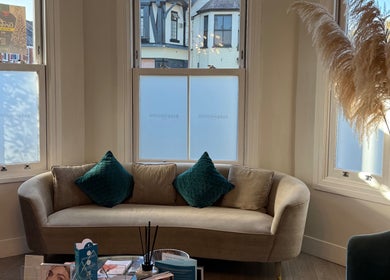Inviting lounge at Energy Flow Therapy, Hale, England, GB with plush sofa and decorative elements.