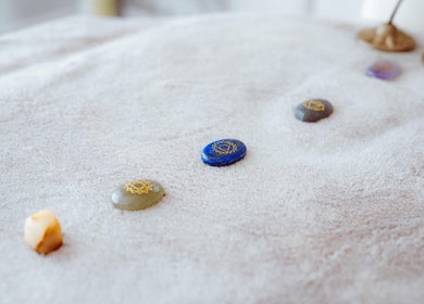 Healing stones on a therapy bed at Energy Flow Therapy, Hale, England, GB, promoting relaxation and balance.