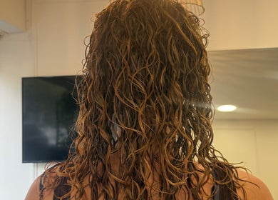 Back view of beautifully styled curly hair at Hair&Beauty24, Waltham Abbey, England, GB.