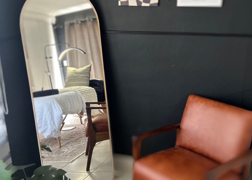 Modern treatment room at Lavin Laser and Aesthetics, Centurion, Gauteng, ZA, featuring stylish seating and decor.