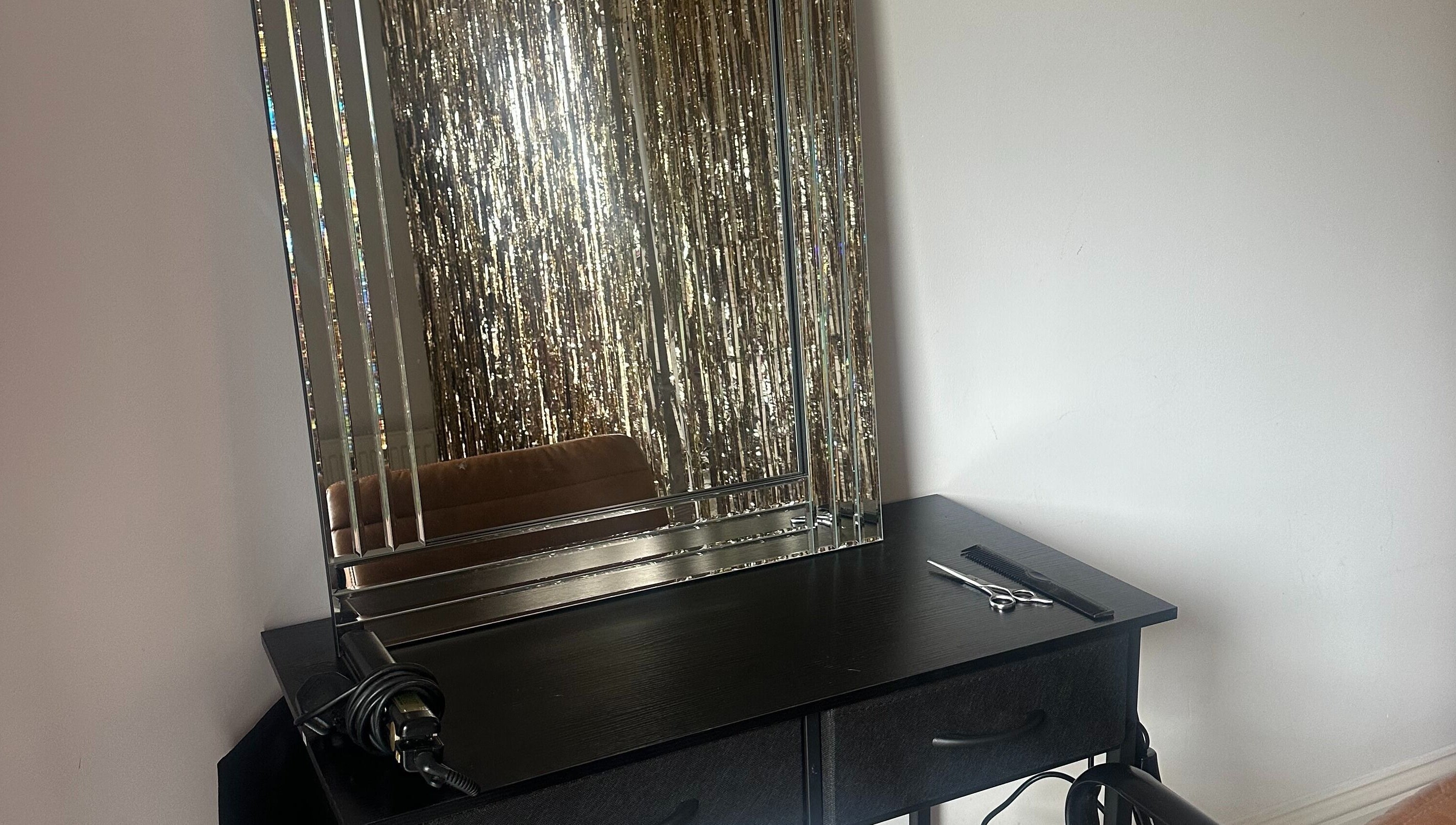 Elegant styling station at Styled by Teresa in London, England, GB with a sleek mirror and tools.