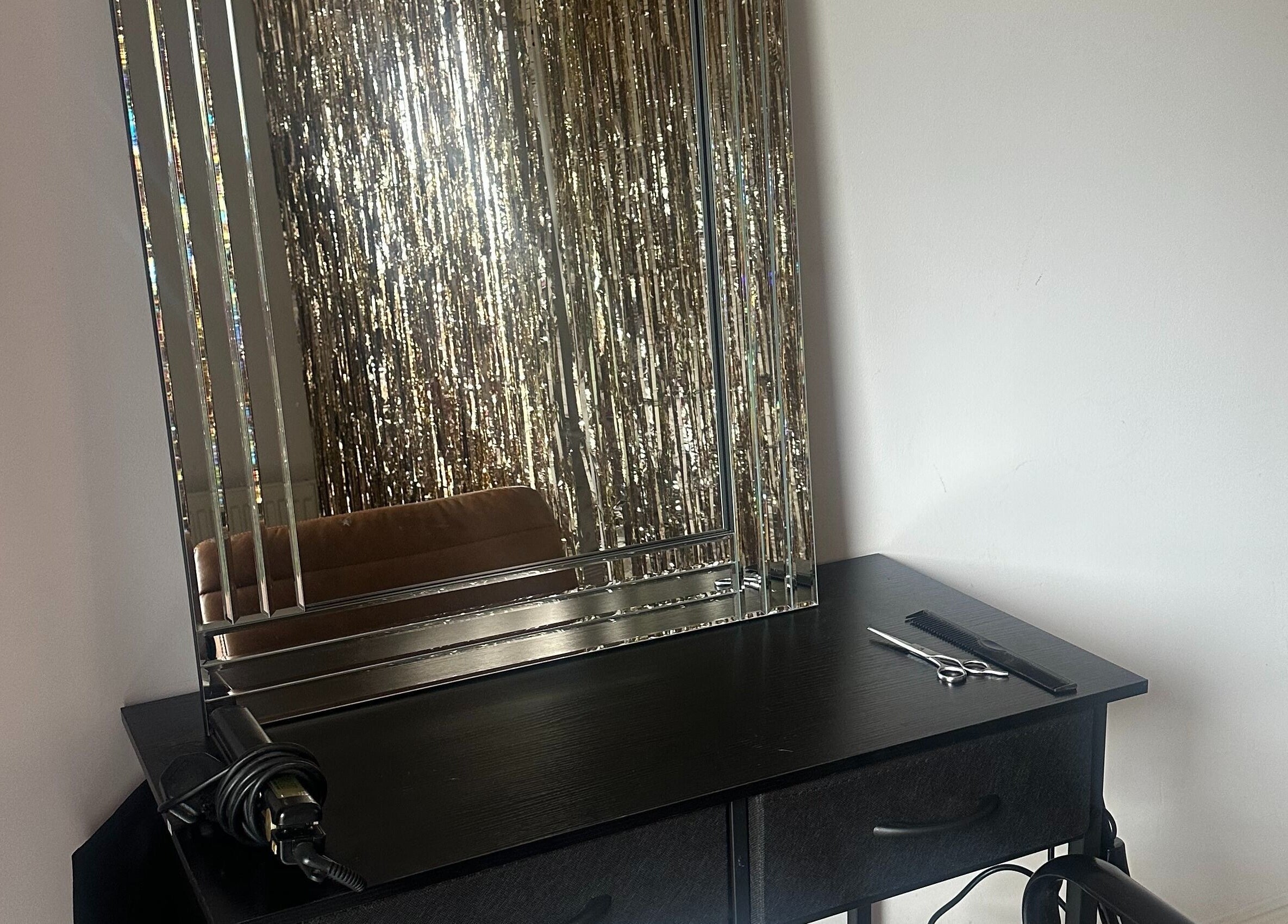 Elegant styling station at Styled by Teresa in London, England, GB with a sleek mirror and tools.