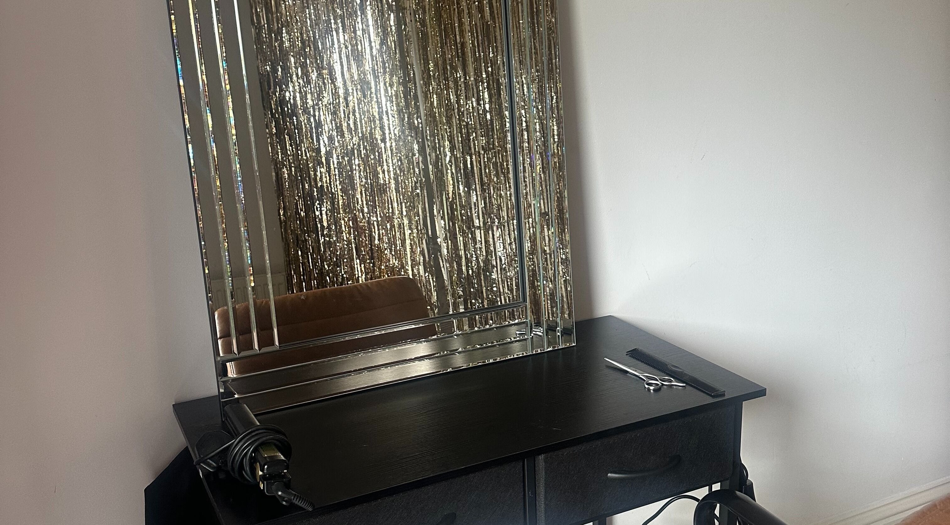 Elegant styling station at Styled by Teresa in London, England, GB with a sleek mirror and tools.