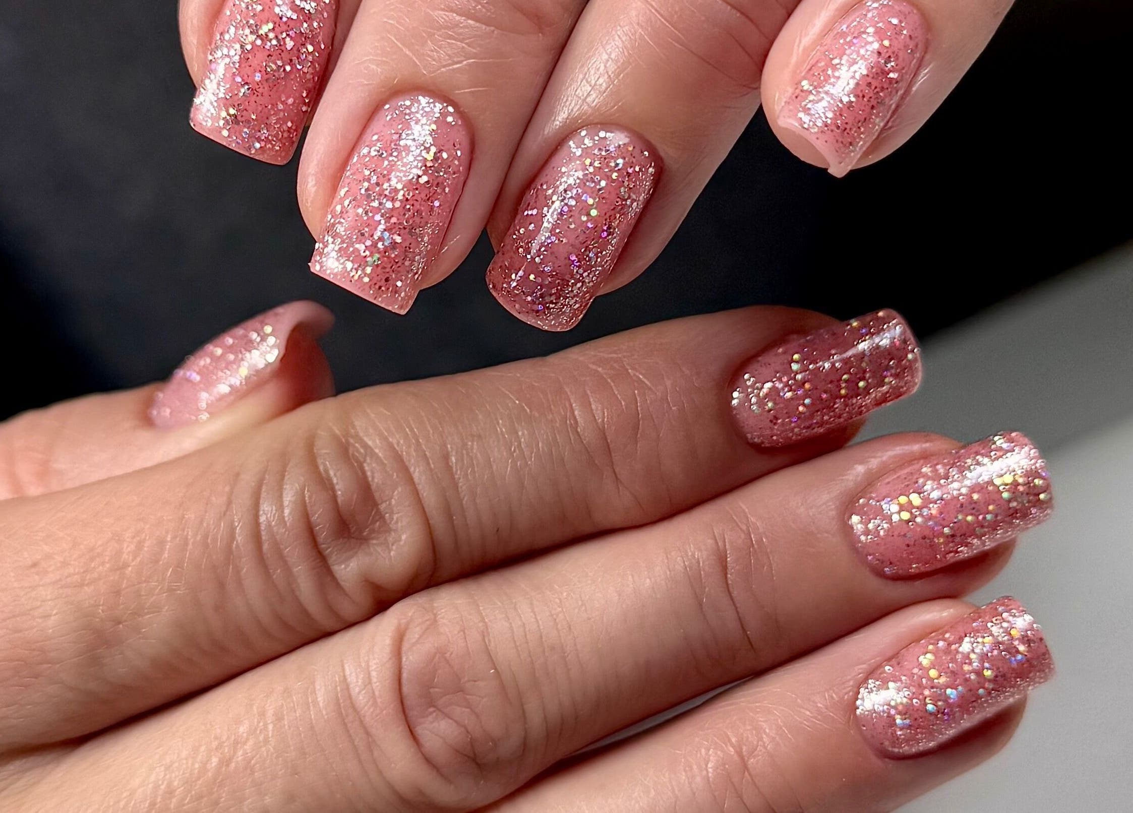 Glittery pink nails manicure at SABeauty, Southborough, England, GB showcasing elegance and style.