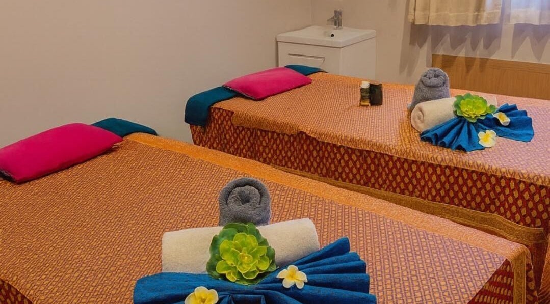 Relaxing massage beds at Hannah Thai Spa in Birmingham, England, GB, adorned with floral decor.