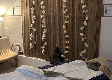 Calming massage room at Hands Of Nature Massage Therapy, Kineton, England, GB, with floral decor and soft lighting.