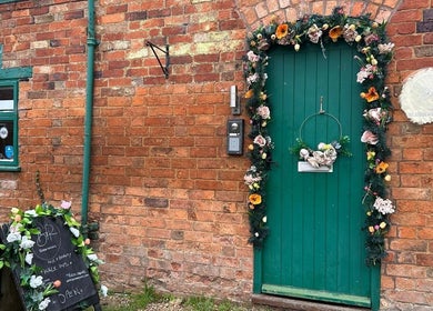Charming entrance at Hands Of Nature Massage Therapy in Kineton, England, GB adorned with floral decor.