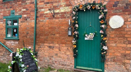 Charming entrance at Hands Of Nature Massage Therapy in Kineton, England, GB adorned with floral decor.