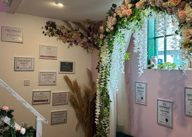 Awards and floral decor at Hands Of Nature Massage Therapy, Kineton, England, GB enhancing serene ambiance.