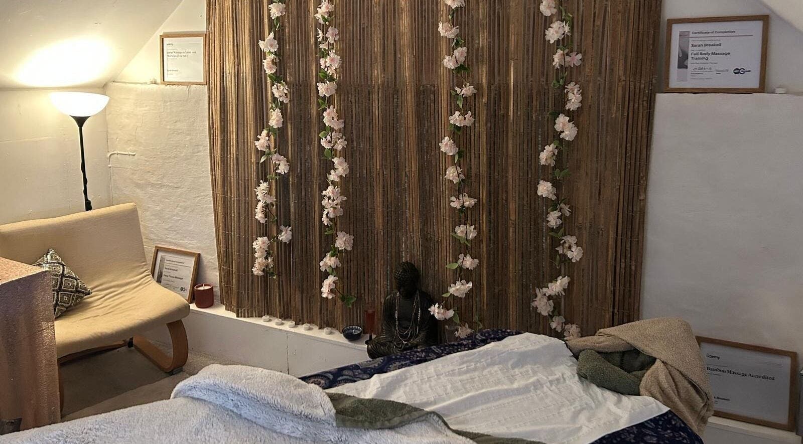 Relaxing massage room at Hands Of Nature Massage Therapy, Kineton, England, GB with floral decor and soft lighting.