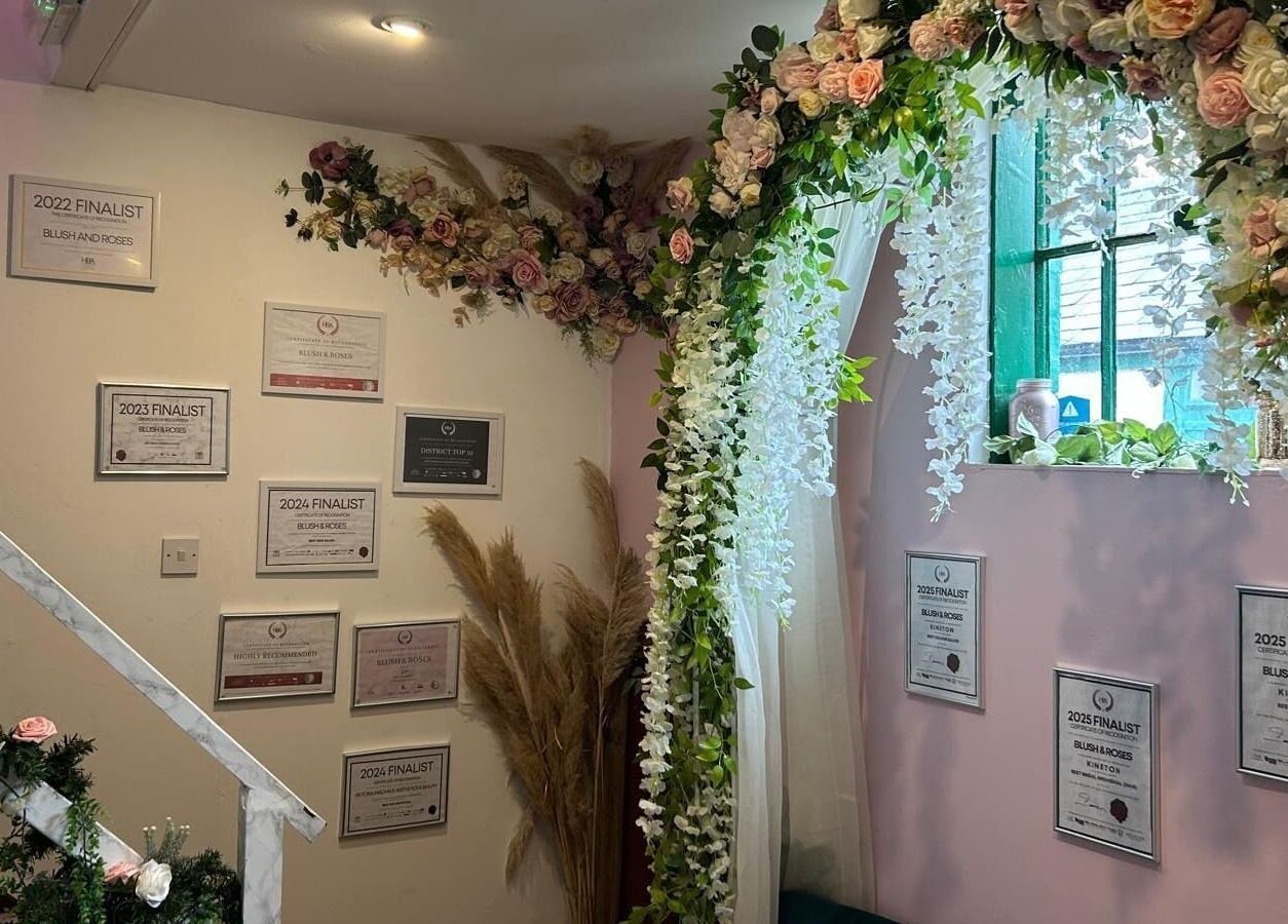 Elegant floral archway and awards display at Hands Of Nature Massage Therapy, Kineton, England, GB.