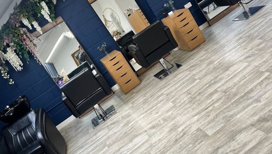 Modern salon chairs and mirrors at JD’s Beauty Bar, Pontyclun, Wales, GB, showcasing style and comfort.